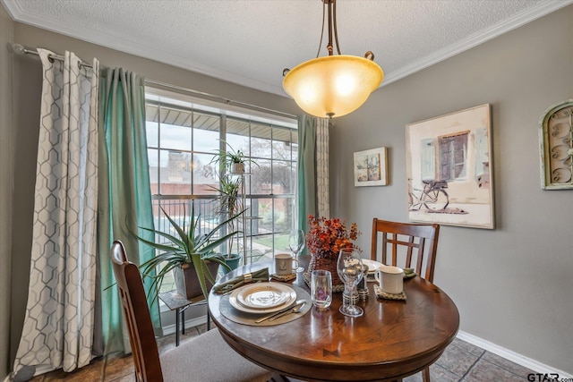 tiled dining area with crown molding and a textured ceiling