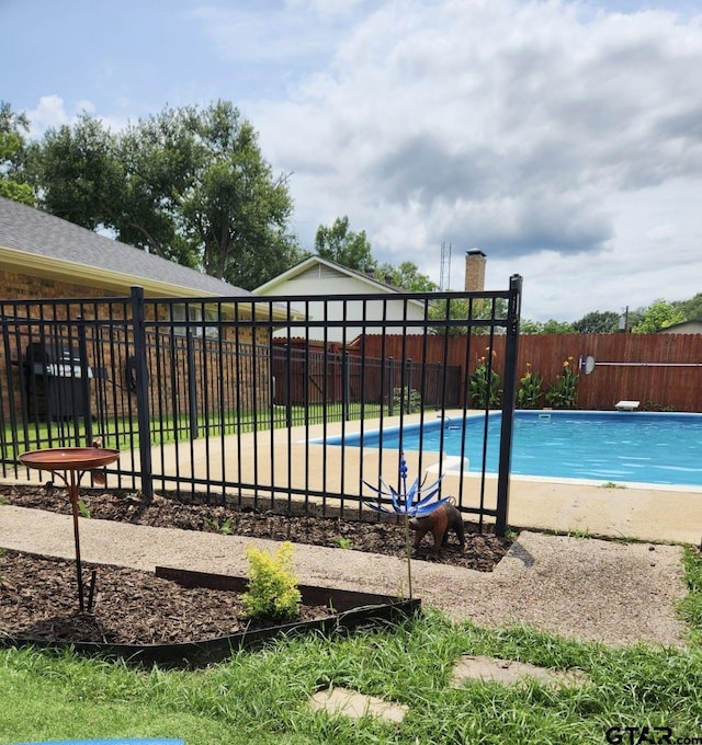 view of pool featuring a diving board