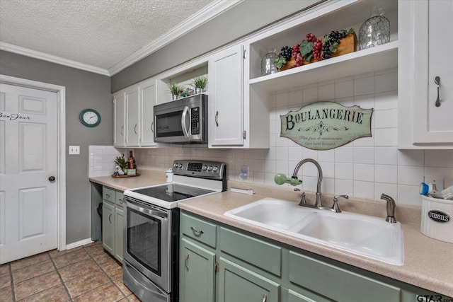 kitchen featuring backsplash, sink, white cabinets, and appliances with stainless steel finishes