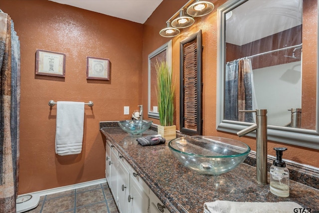 bathroom featuring tile patterned flooring, vanity, and a shower with curtain