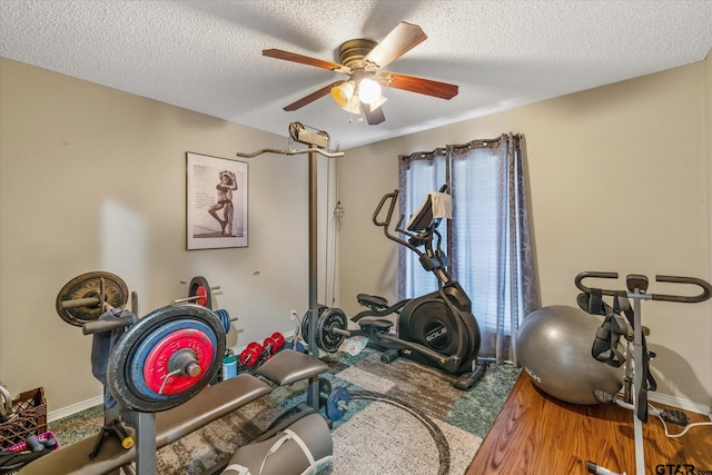 workout area with a textured ceiling, hardwood / wood-style flooring, ceiling fan, and a healthy amount of sunlight