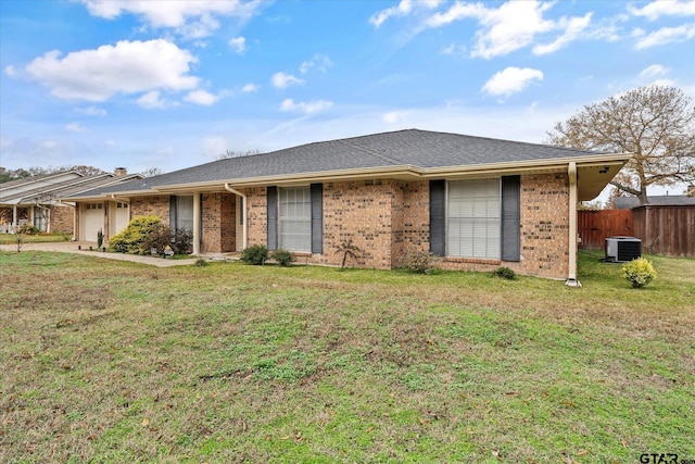 single story home with cooling unit, a garage, and a front lawn