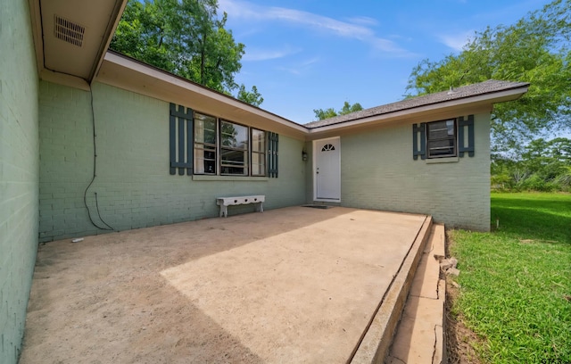507 Bascom Rd, Whitehouse, TX 75791 - property entrance with brick siding, a patio, and a yard