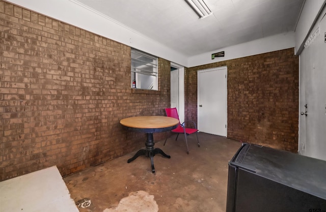 507 Bascom Rd, Whitehouse, TX 75791 - dining room featuring unfinished concrete flooring and brick wall