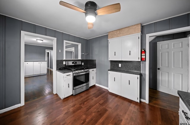 507 Bascom Rd, Whitehouse, TX 75791 - kitchen with stainless steel gas stove, a ceiling fan, a decorative wall, dark countertops, and decorative backsplash