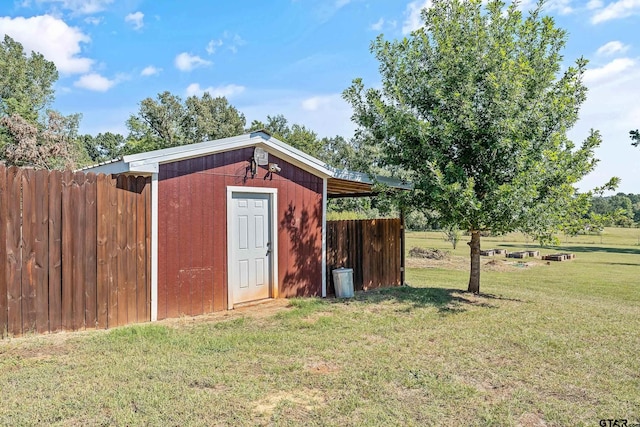 view of shed featuring fence