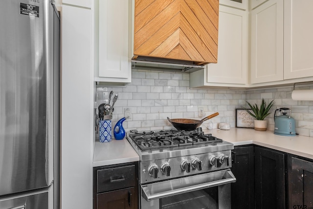 kitchen with backsplash, white cabinetry, appliances with stainless steel finishes, light countertops, and custom exhaust hood