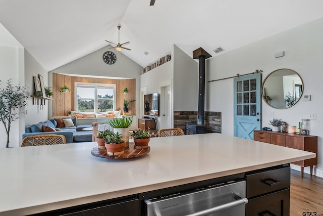 kitchen with visible vents, light wood-type flooring, open floor plan, dishwasher, and ceiling fan