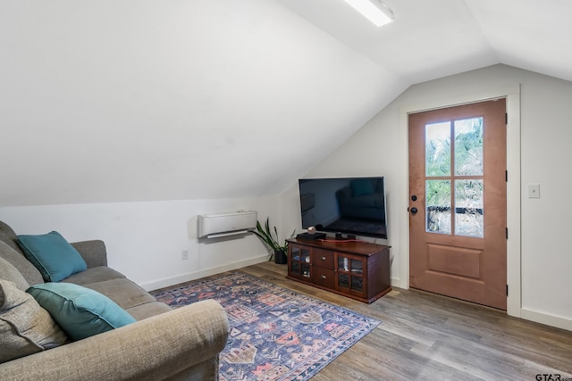 living room with baseboards, lofted ceiling, and wood finished floors