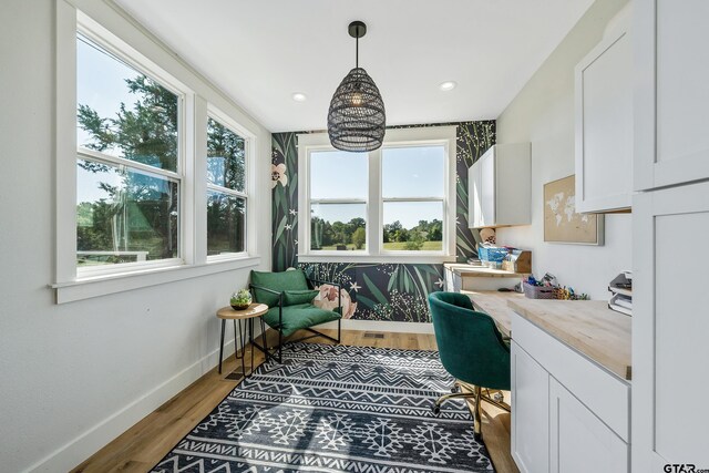 office space with recessed lighting, wood finished floors, built in desk, and baseboards