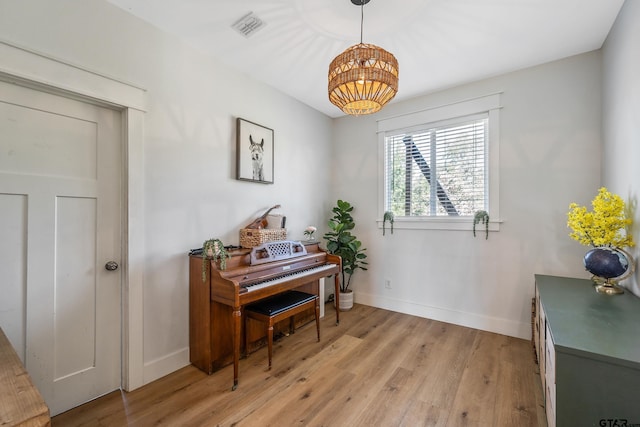 interior space with light wood-style flooring, baseboards, and visible vents