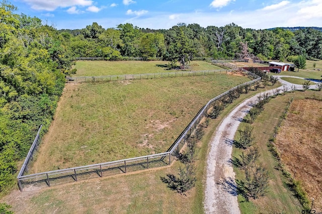 aerial view featuring a rural view and a wooded view