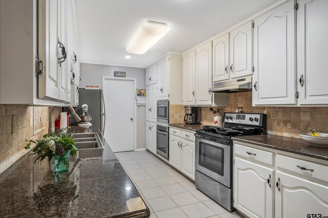 110 Leisure Ln, Whitehouse, TX 75791 - kitchen featuring white cabinets, under cabinet range hood, a sink, stainless steel appliances, and backsplash