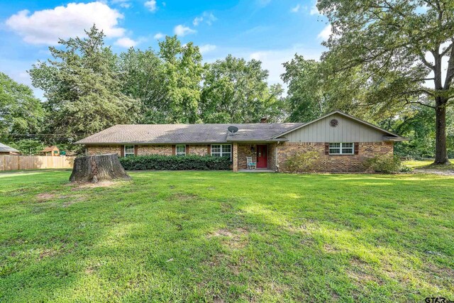 110 Leisure Ln, Whitehouse, TX 75791 - ranch-style house featuring a chimney, fence, a front lawn, and brick siding