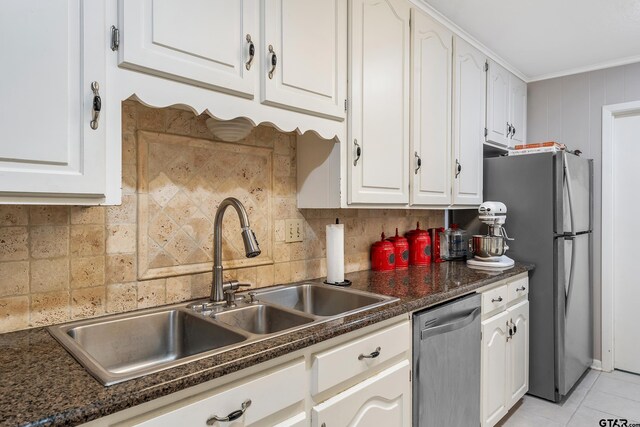110 Leisure Ln, Whitehouse, TX 75791 - kitchen with dark countertops, a sink, white cabinets, and stainless steel appliances