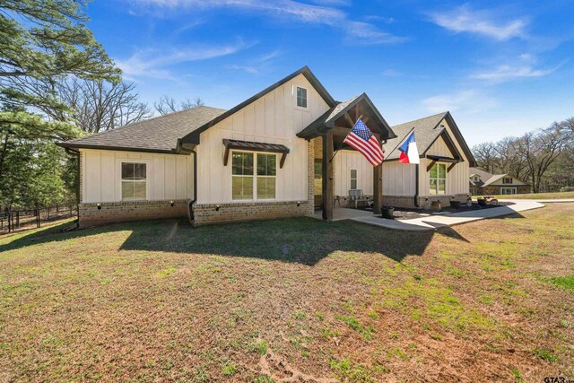 15920 Shepards Gln, Lindale, TX 75771 - modern inspired farmhouse with fence, roof with shingles, a front lawn, board and batten siding, and brick siding