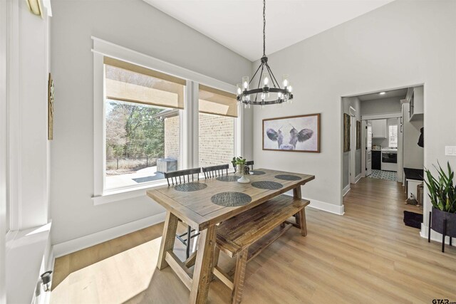 15920 Shepards Gln, Lindale, TX 75771 - dining room featuring a notable chandelier, light wood-style flooring, and baseboards