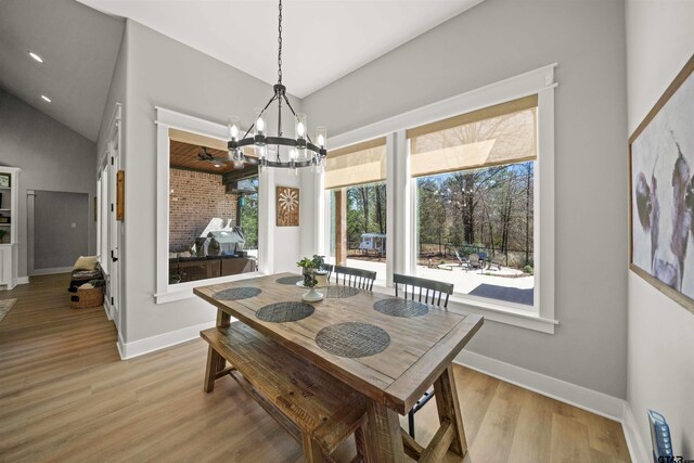 15920 Shepards Gln, Lindale, TX 75771 - dining area featuring lofted ceiling, light wood-style flooring, baseboards, and a chandelier