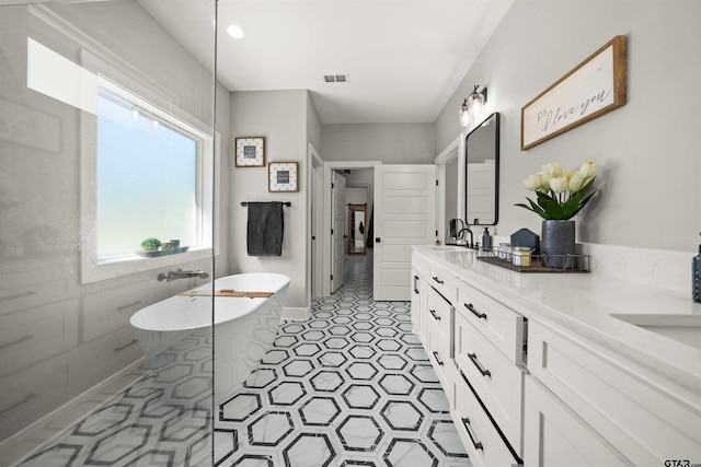 15920 Shepards Gln, Lindale, TX 75771 - full bath with visible vents, double vanity, a freestanding tub, a sink, and tile patterned flooring
