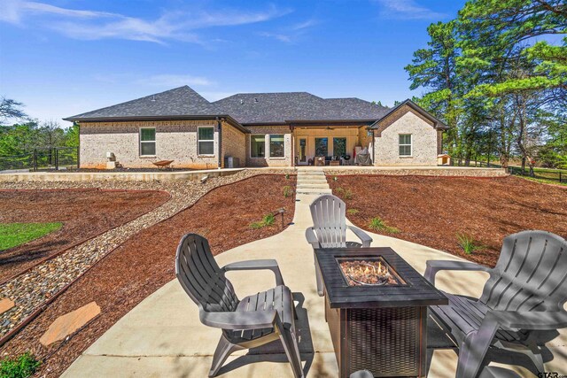 15920 Shepards Gln, Lindale, TX 75771 - back of property with brick siding, fence, an outdoor fire pit, french doors, and a patio