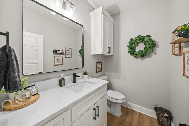 15920 Shepards Gln, Lindale, TX 75771 - half bathroom with baseboards, toilet, wood finished floors, and vanity