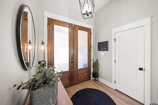 15920 Shepards Gln, Lindale, TX 75771 - foyer entrance with light wood-type flooring, french doors, baseboards, and a chandelier