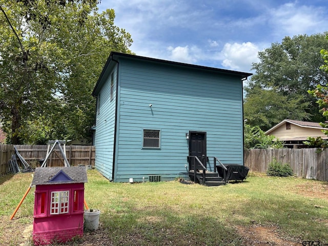 rear view of house with a yard