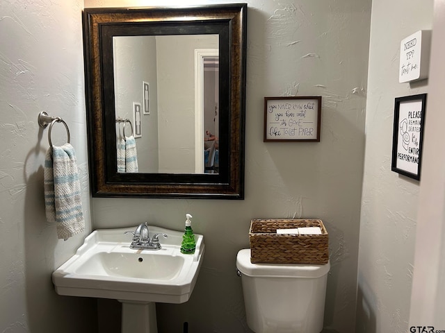 bathroom with sink and toilet