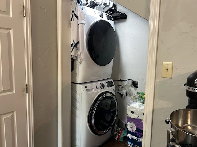 laundry area with stacked washing maching and dryer