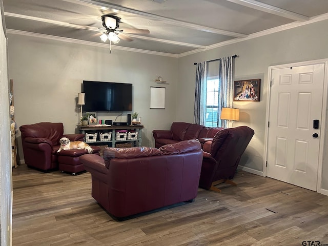 living room with ornamental molding, beamed ceiling, hardwood / wood-style flooring, and ceiling fan