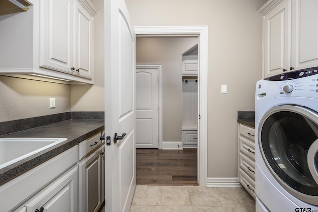 7022 Walden Dr, Tyler, TX 75703 - laundry area featuring washer / clothes dryer and cabinet space