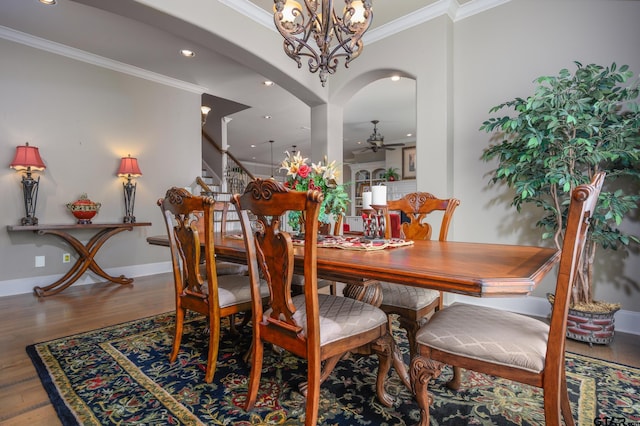 7022 Walden Dr, Tyler, TX 75703 - dining room with ornamental molding, ceiling fan, wood finished floors, stairs, and arched walkways