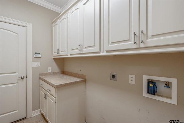 laundry area featuring cabinets, hookup for an electric dryer, ornamental molding, washer hookup, and light tile patterned flooring