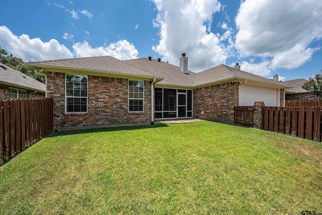 665 Bunker Dr, Tyler, TX 75703 - back of house featuring an attached garage, brick siding, a fenced backyard, and a sunroom