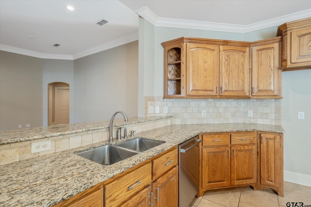 665 Bunker Dr, Tyler, TX 75703 - kitchen with stainless steel dishwasher, light stone counters, arched walkways, decorative backsplash, and ornamental molding