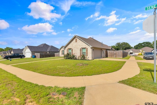 19175 Seneca Dr, Flint, TX 75762 - view of home's exterior featuring concrete driveway, an attached garage, brick siding, and a residential view