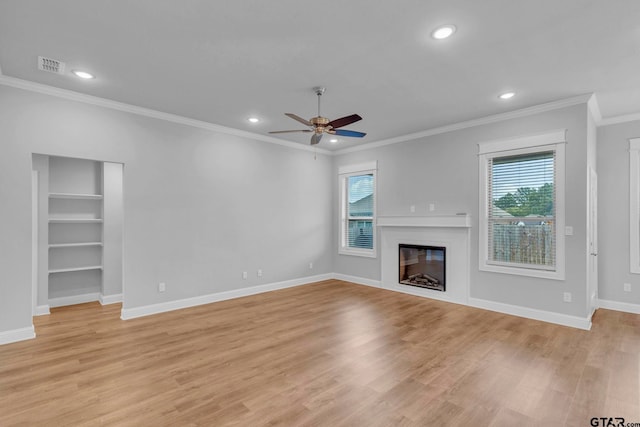19175 Seneca Dr, Flint, TX 75762 - unfurnished living room with healthy amount of natural light, a ceiling fan, ornamental molding, recessed lighting, and light wood-style floors