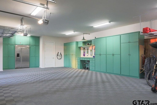 garage featuring built in refrigerator and a garage door opener