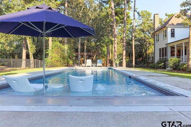 view of swimming pool with fence and a fenced in pool