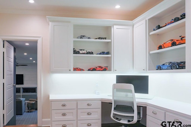 home office with built in desk, built in shelves, and recessed lighting