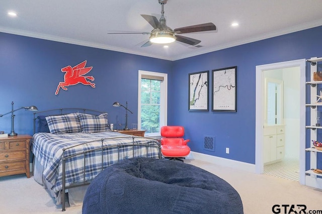 carpeted bedroom with baseboards, ensuite bath, visible vents, and crown molding