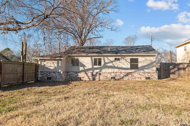 back of property featuring a lawn