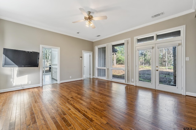 unfurnished living room with wood-type flooring, visible vents, crown molding, and french doors