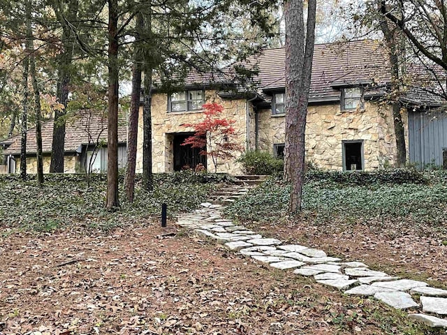 exterior space featuring stone siding