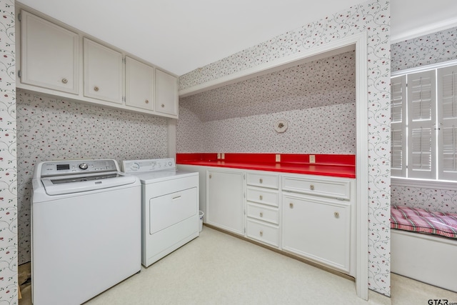 laundry room featuring cabinet space, washing machine and clothes dryer, and wallpapered walls