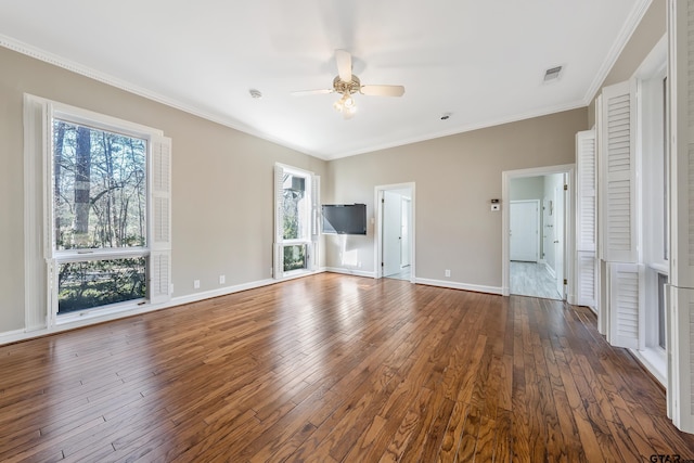 unfurnished bedroom featuring hardwood / wood-style flooring, baseboards, multiple windows, and ornamental molding