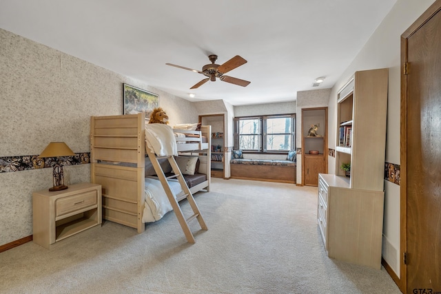 bedroom featuring light carpet, ceiling fan, and wallpapered walls