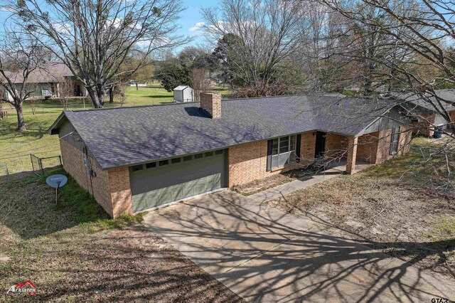 single story home with a garage and a front yard