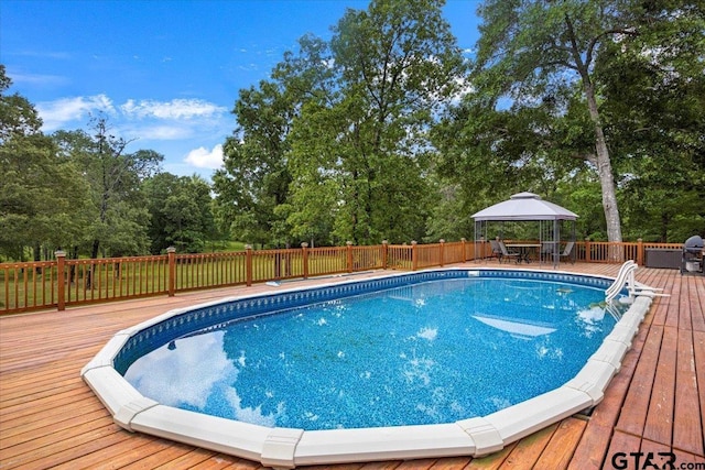 view of pool featuring outdoor dining area, a wooden deck, a gazebo, and fence