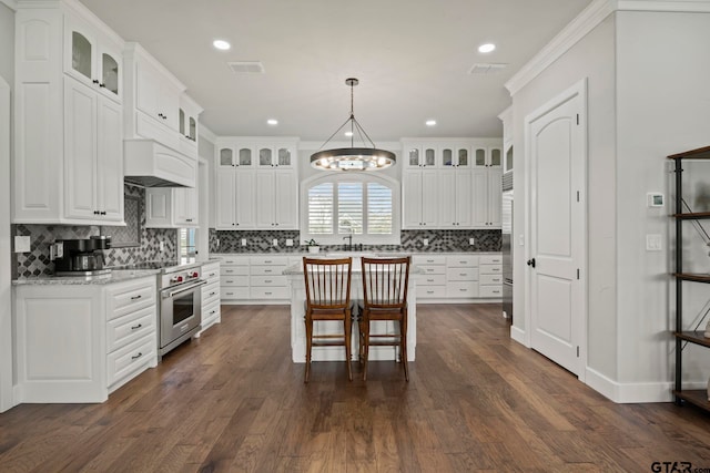 kitchen with white cabinetry, a chandelier, dark hardwood / wood-style floors, and designer range